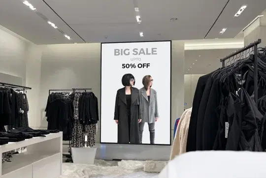 Retail store with digital signage displaying BIG SALE UPTO 50% OFF