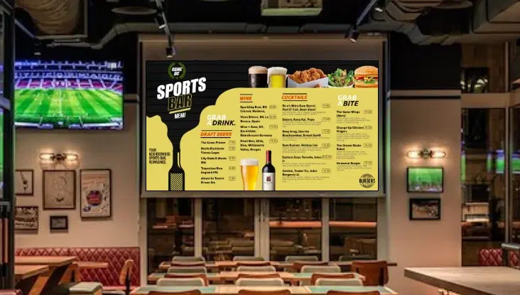 A bar with digital menu boards showing drinks and food menu