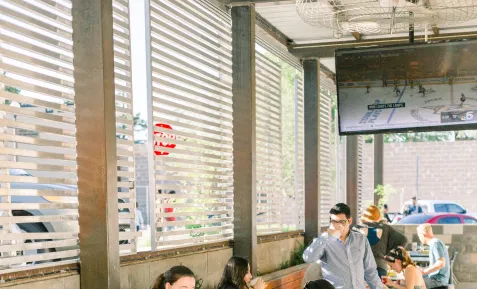 Digital signage placed in office canteen displaying news update feed from Pickcel's digital signage ESPN news app