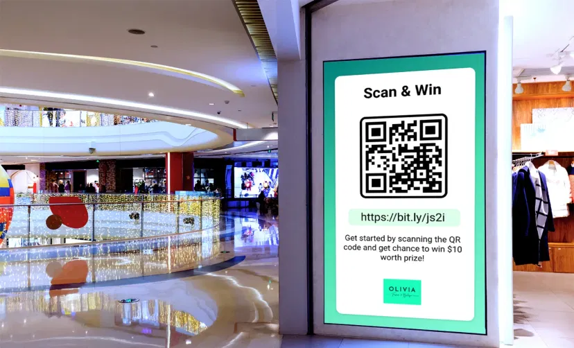 Digital signage screen in retail and corporate environment displaying QR code using Pickcel software