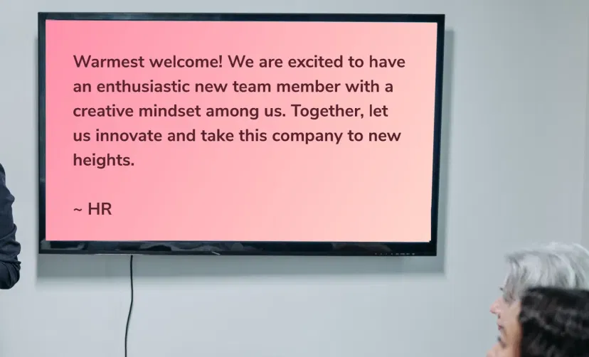 Digital signage screens in an office showing Text Board using Pickcel digital signage software