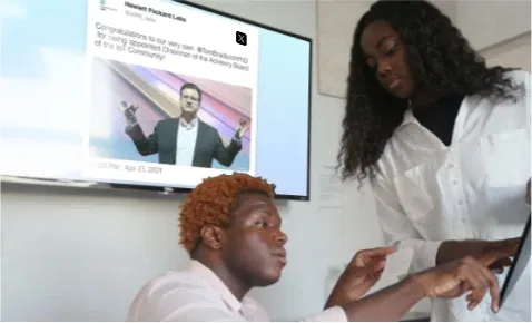 Digital signage screen placed at office meeting room showing brand's tweets using Pickcel's Twitter Plus app.