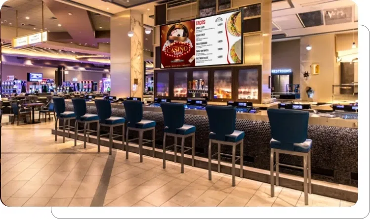 Digital signage screen showing streamlined digital menus and dining specials at casino