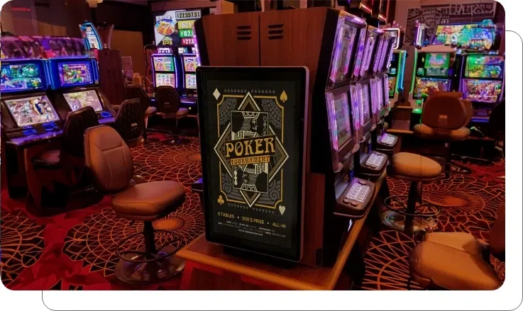 Digital signage screen showing e-gaming floor with live feeds and tournament displays at casino